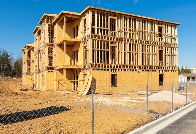 a close-up of temporary chain link fences enclosing a job site, signaling progress in the project's development in South Dartmouth, MA